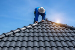 roof repair worker replacing tiles