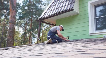 a worker repairs a soft roof