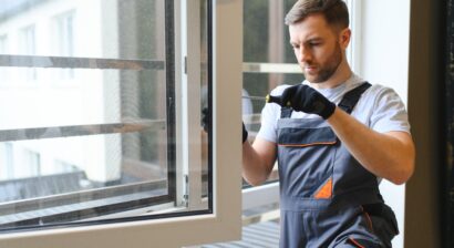 worker in overalls installing windows