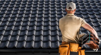 professional roofing work working on a black ceramic roof