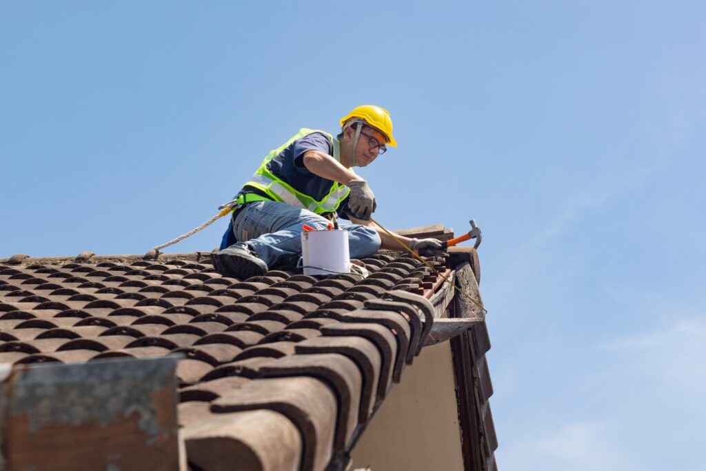 worker repairing roof