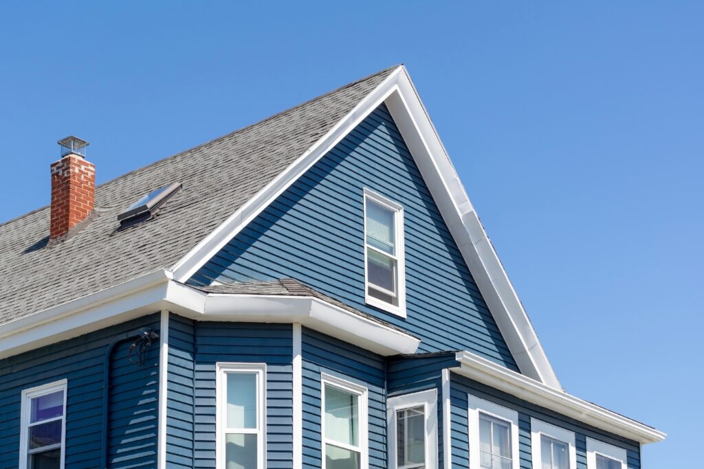 blue sided gable roof against clear sky