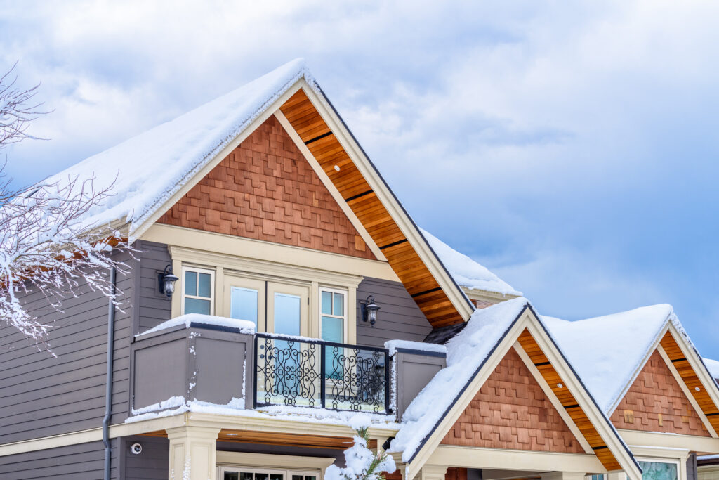 the top of a typical american home in winter with snow