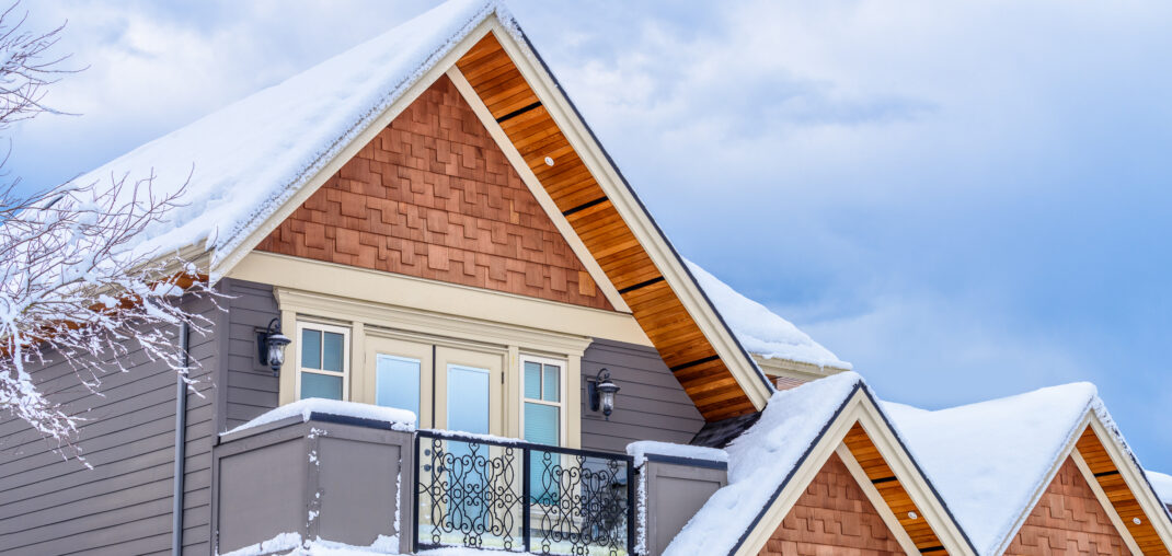 the top of a typical american home in winter with snow