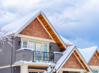 the top of a typical american home in winter with snow