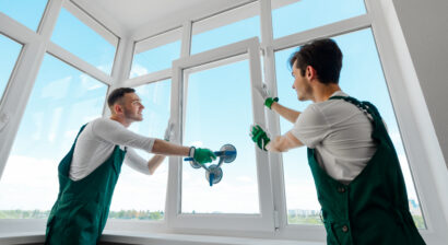 men installing a window in an apartment