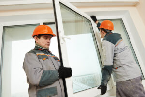 two male industrial builders at window installation
