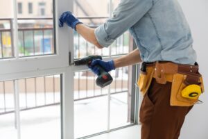 worker installing window in the house