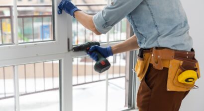 worker installing window in the house