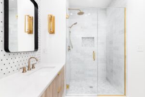a bathroom with gold accents