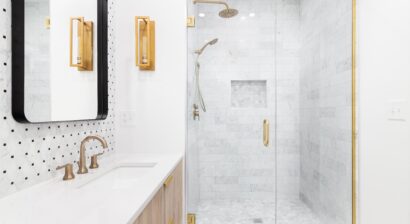 a bathroom with gold accents