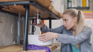 young woman placing water under