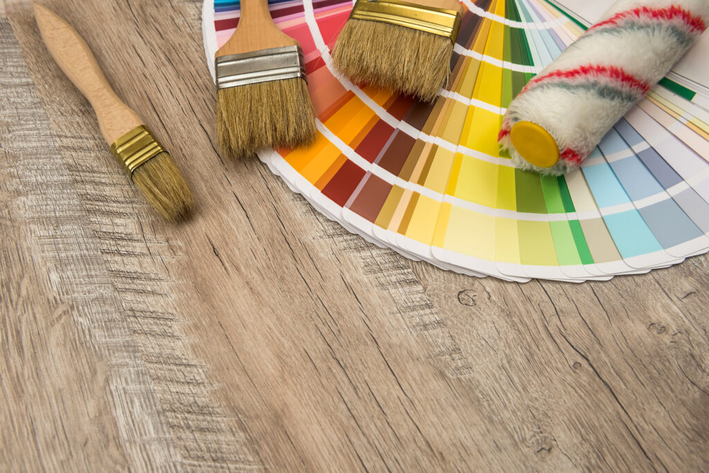 color paint guide and paint brush on wooden board