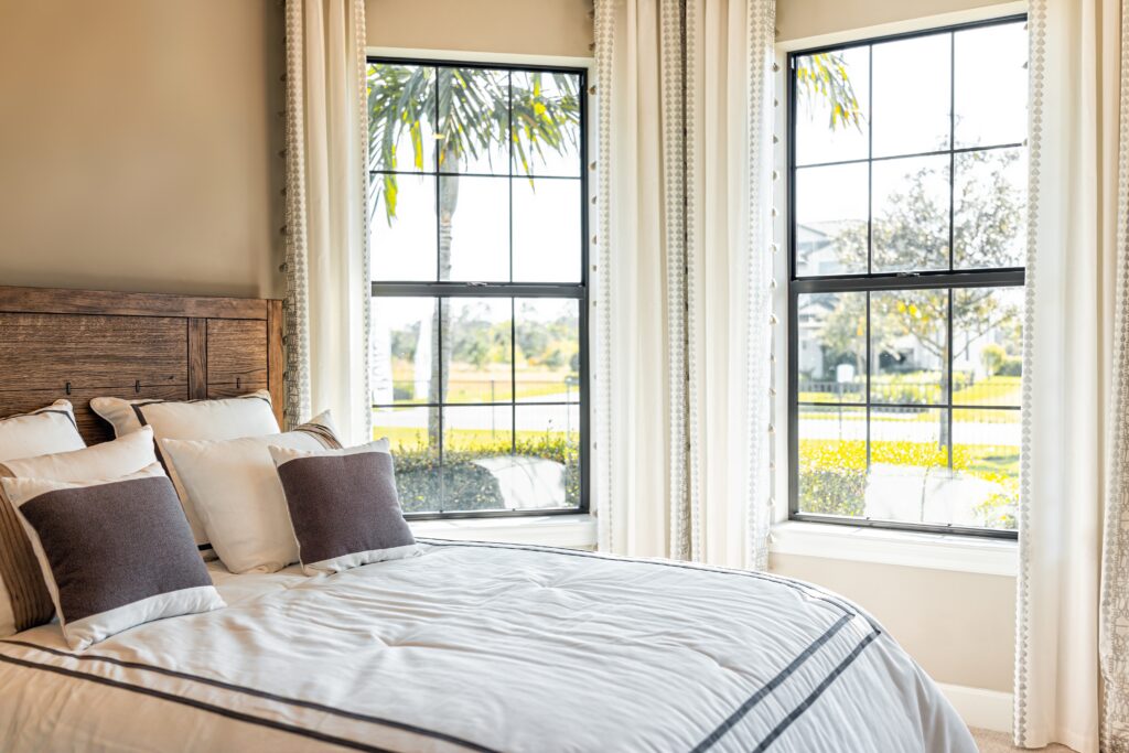 made bed with decorative windows in home of a house