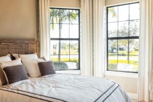made bed with decorative windows in home of a house