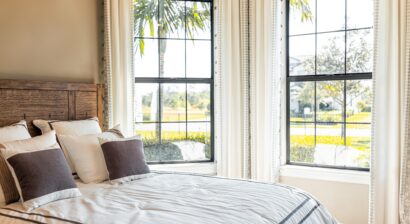 made bed with decorative windows in home of a house