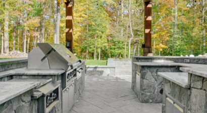 inviting partially covered outdoor patio with stone kitchen