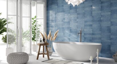 luxurious bathroom interior with white bathtub and blue walls