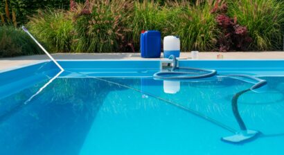 a clear blue pool with a cleaning hose