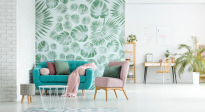 pink arm chair and blue couch with blanket in bright room