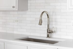 kitchen sink detail short with a white tile backsplash