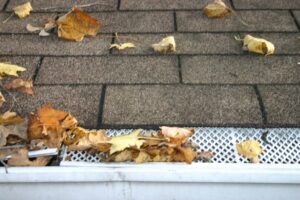 roof with gutter guard covered in leaves
