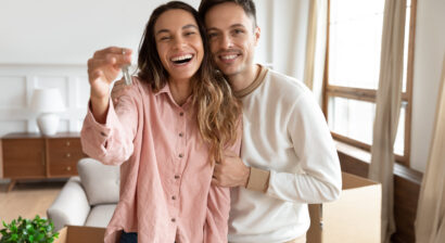 happy young couple holding keys to new home