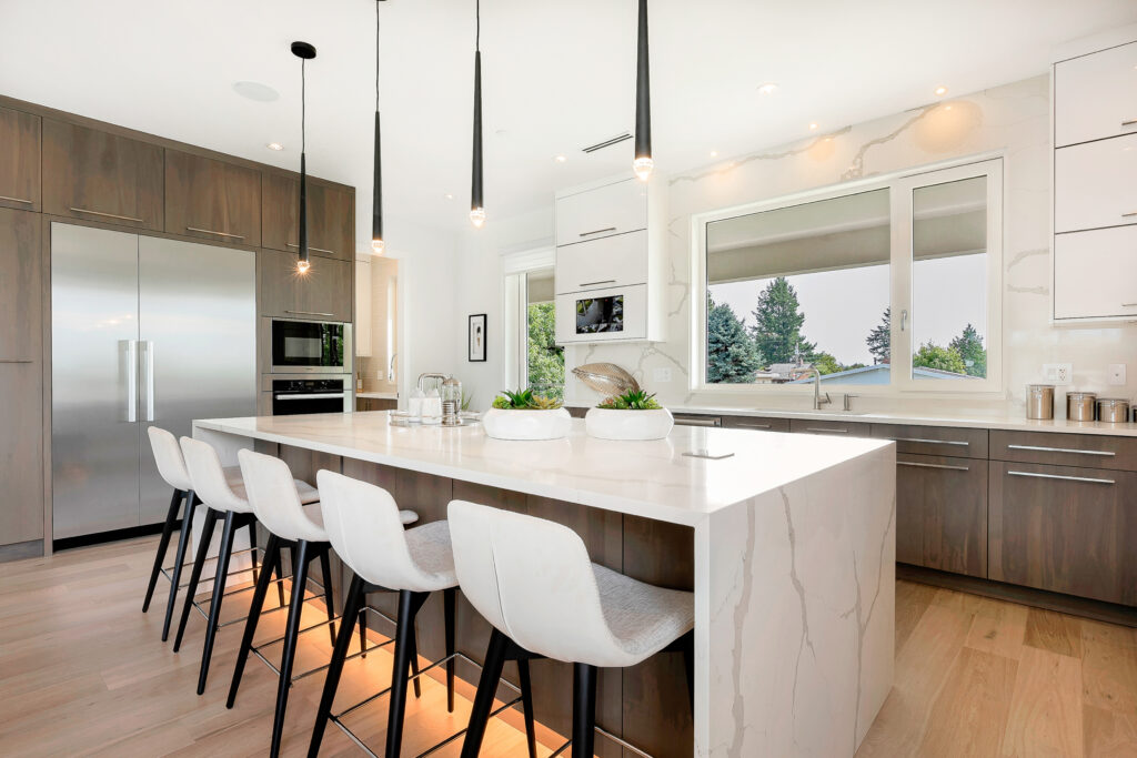 elegant house with open concept and white kitchen chairs around a white marble island