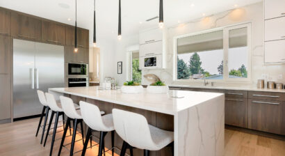 elegant house with open concept and white kitchen chairs around a white marble island