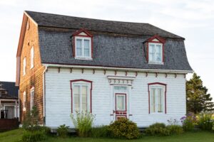 pretty white classic house with mansard roof