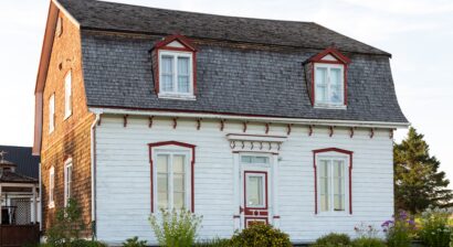 pretty white classic house with mansard roof