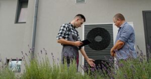 hvac technician consults with homeowner about unit