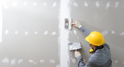 construction worker in uniform and hardhat working on interior