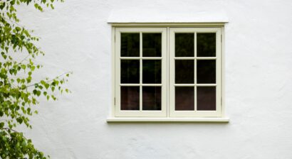 house exterior with wooden windows on white walls