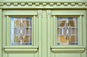 green wooden doors with stained glass windows