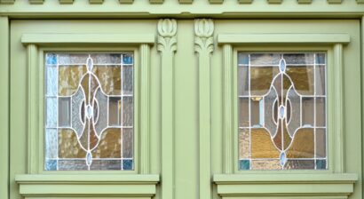 green wooden doors with stained glass windows