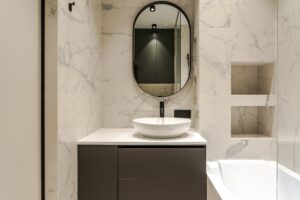 the interior of a small modern bathroom with a sink directly next to the shower