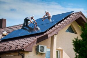 workers building solar panel system on roof of home