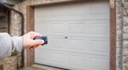 garage door and hand holding remote