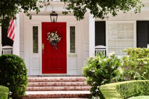 elegant white house with bright red front door