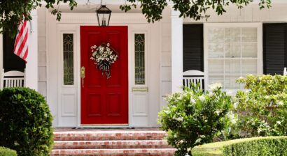 elegant white house with bright red front door