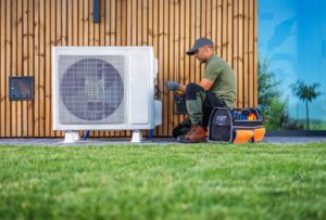 technician servicing an air condition unit located beside a home
