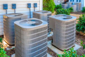 horizontal shot of four air conditioners outside home