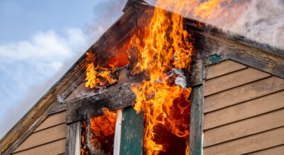 a two story home fully engulfed in flames