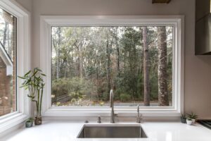 large farmhouse sink with big picture window in kitchen