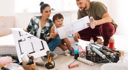 woman with her husband and child looking at papers