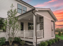 home with sunset in background and front porch