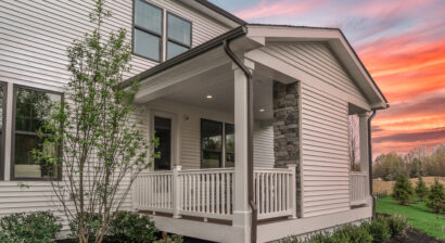 home with sunset in background and front porch