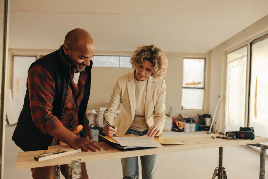 happy homeowner and a construction worker