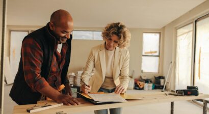 happy homeowner and a construction worker